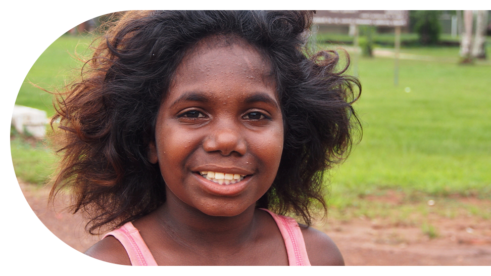 Young indigenous Australian in park smiling at camera
